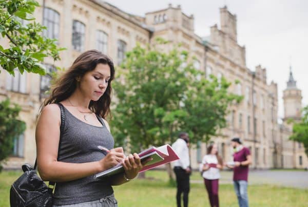 Girl Holding Notebook Writing Standing Outside