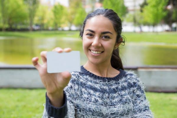 Smiling Young Woman Showing Blank Business Card City Park 600x403