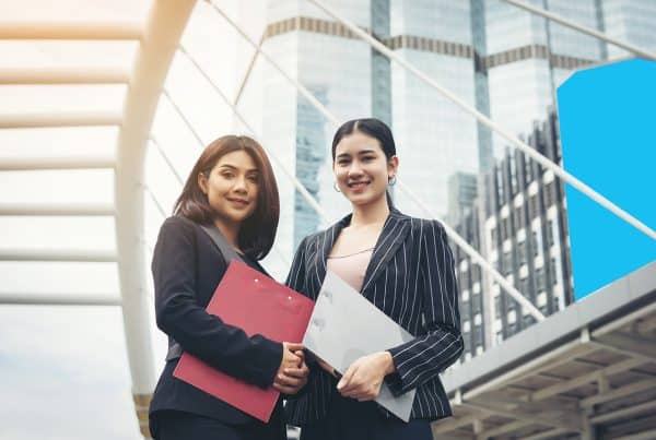 Two Business Woman Standing Discussing Front Office Business Working Concept